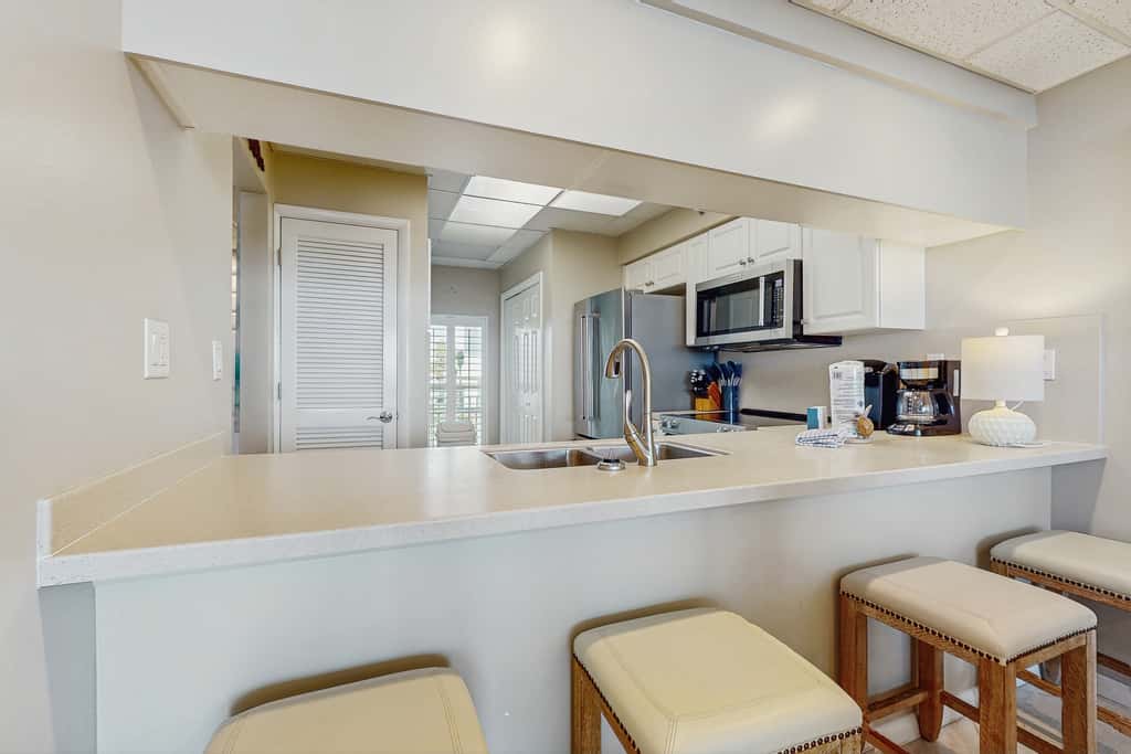 Open-concept beachfront home with balcony, lagoon pool, beach access, pickleball