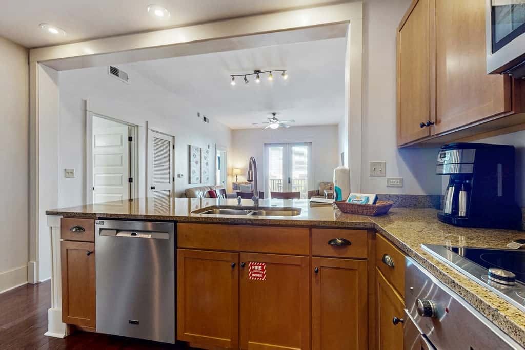 Polished condo with balcony & pools - one block from the beach