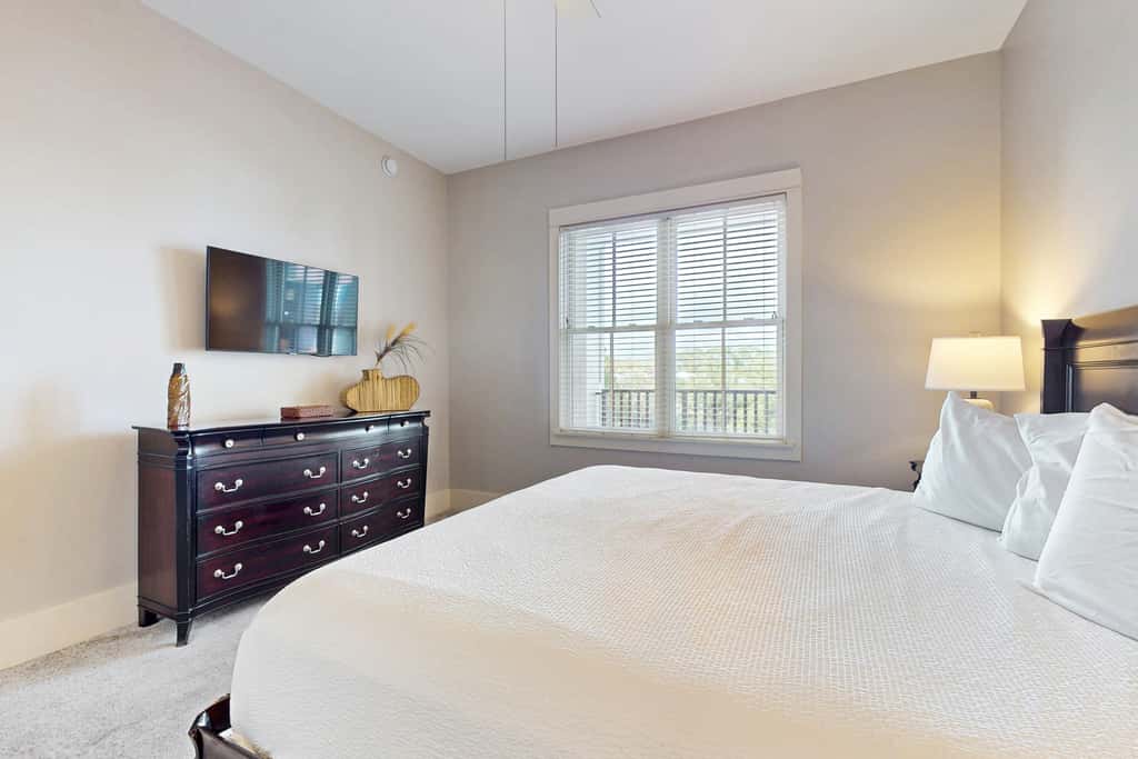 Polished condo with balcony & pools - one block from the beach