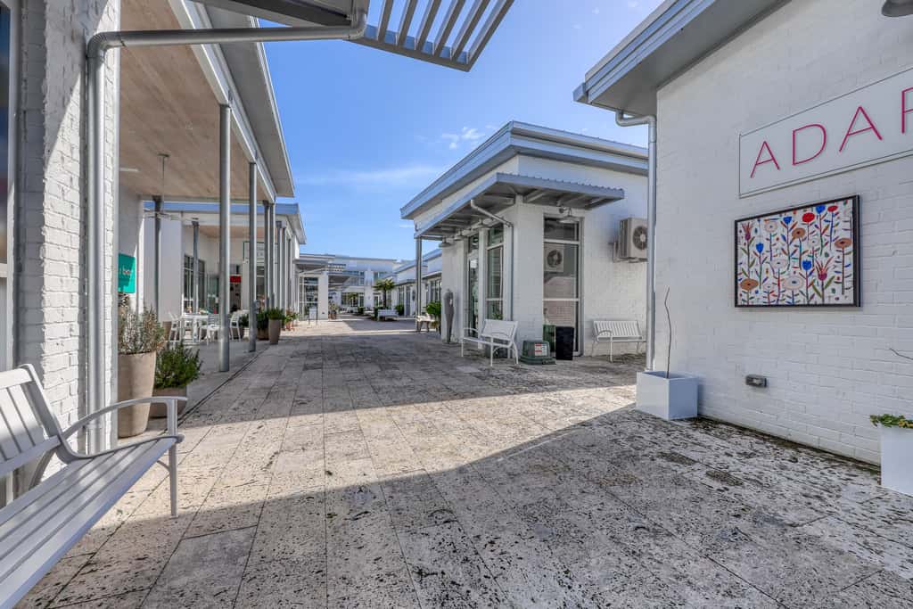 Top floor condo steps to the beach Shared pool & close to shopping & dining