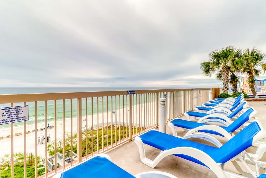 Elegant, beachfront condo with a furnished balcony, views & two pools