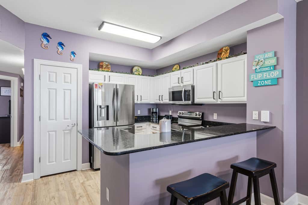 Elegant, beachfront condo with a furnished balcony, views & two pools