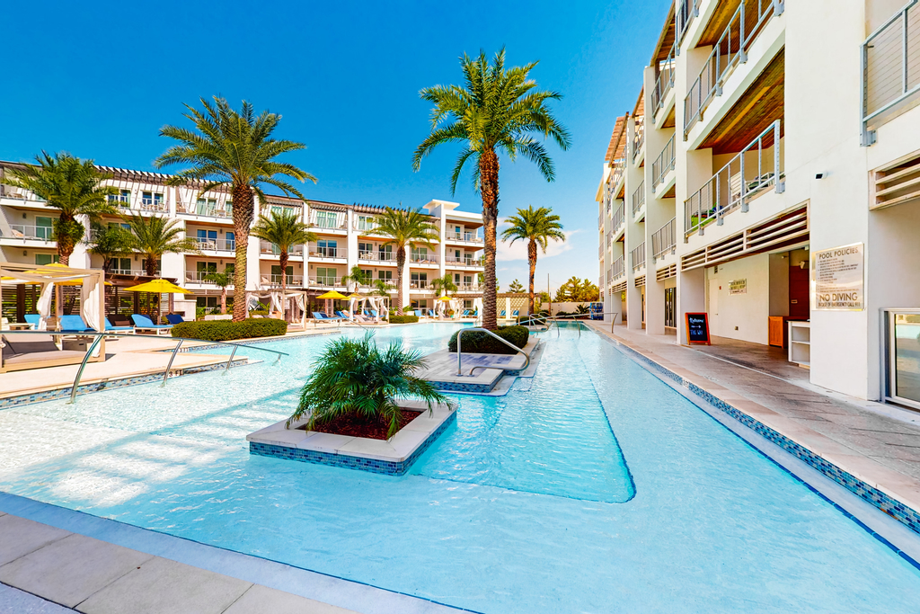 Chic condo steps from beach with patio, W&D, AC, and resort-style pool and gym