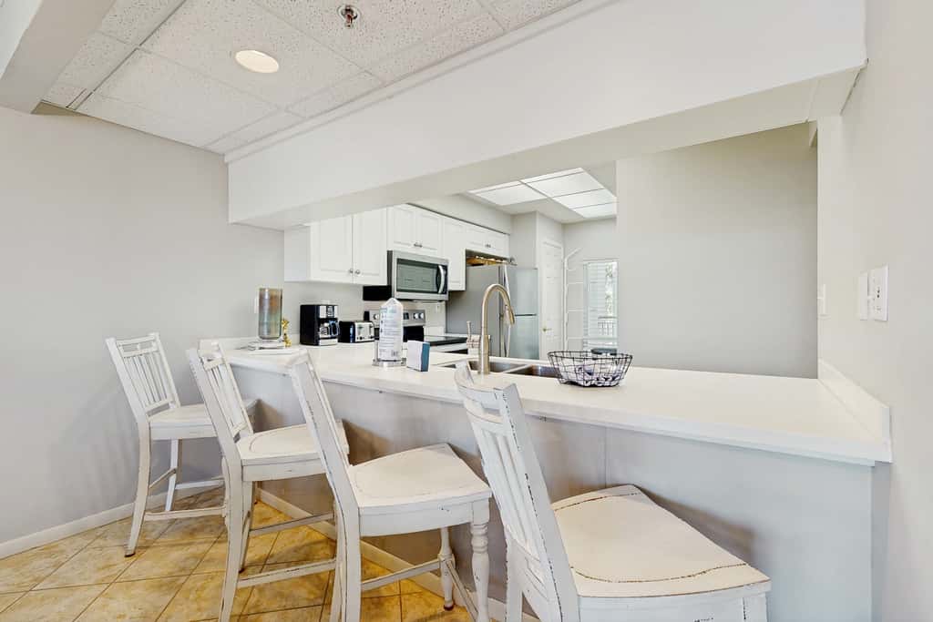 Airy beachfront condo with balcony views, lagoon pool, tennis & pickleball