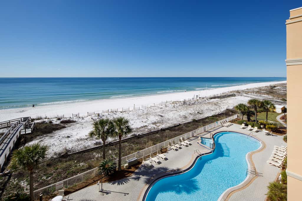 Gulf-view condo with beachfront access, pool, hot tub, gym, AC, & washer&dryer