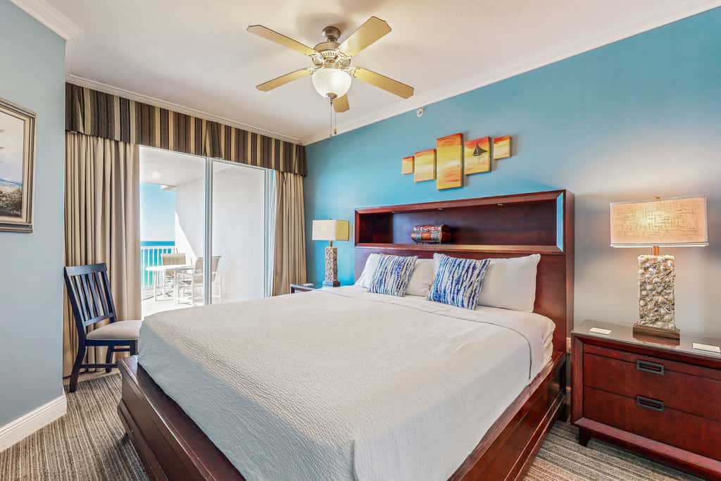 Beachfront condo with beach chairs, an umbrella, and a pool