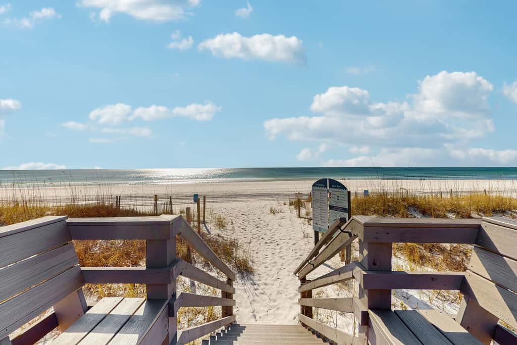 Beautiful seaside condo featuring a sparkling pool and direct beach access