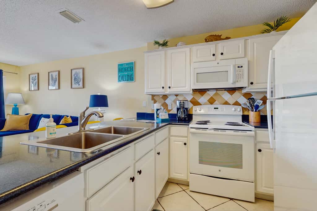 Beautiful seaside condo featuring a sparkling pool and direct beach access