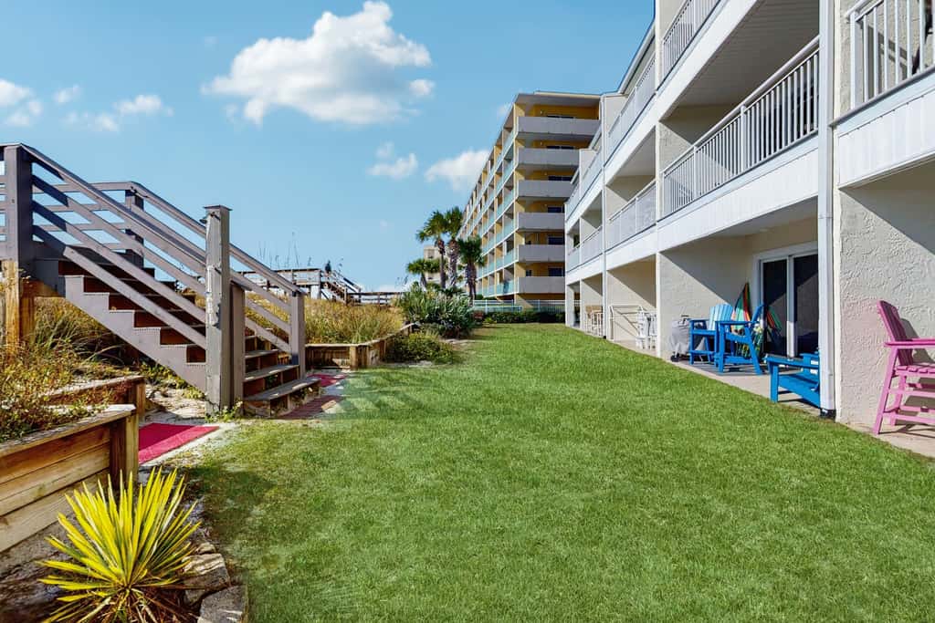 Beautiful seaside condo featuring a sparkling pool and direct beach access