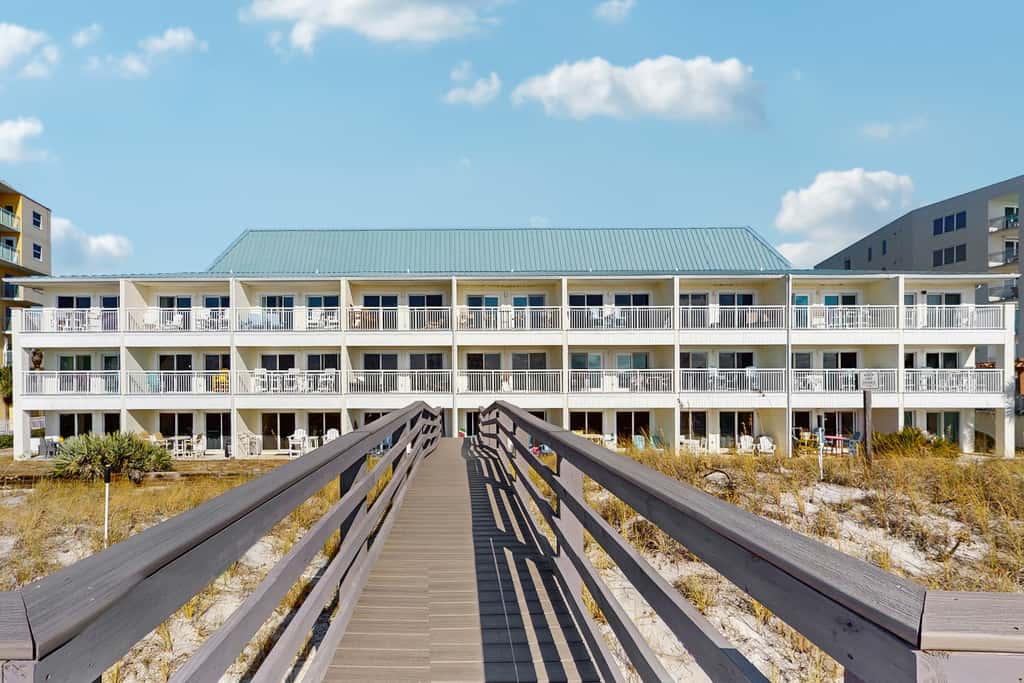 Beautiful seaside condo featuring a sparkling pool and direct beach access