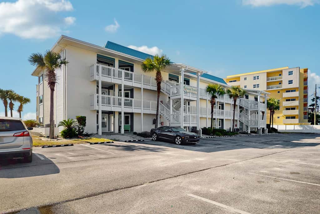 Beautiful seaside condo featuring a sparkling pool and direct beach access