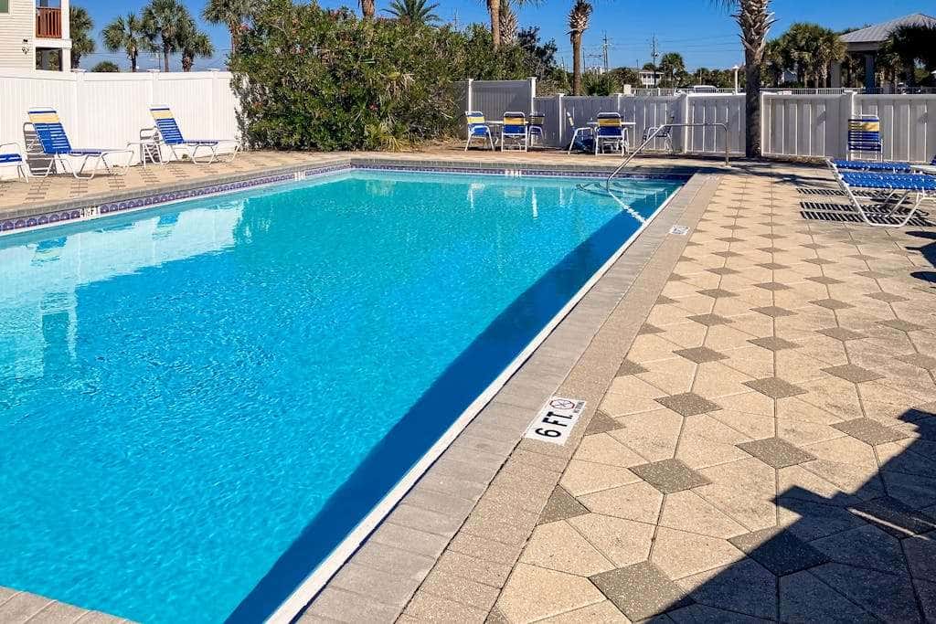 Beautiful seaside condo featuring a sparkling pool and direct beach access