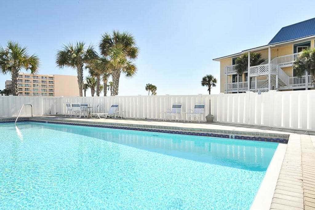 Beautiful seaside condo featuring a sparkling pool and direct beach access