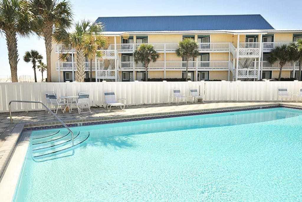 Beautiful seaside condo featuring a sparkling pool and direct beach access