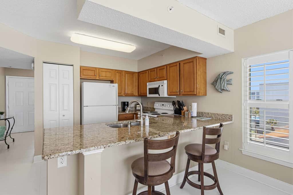 Spacious beachfront condo with full kitchen, shared pool and beach access