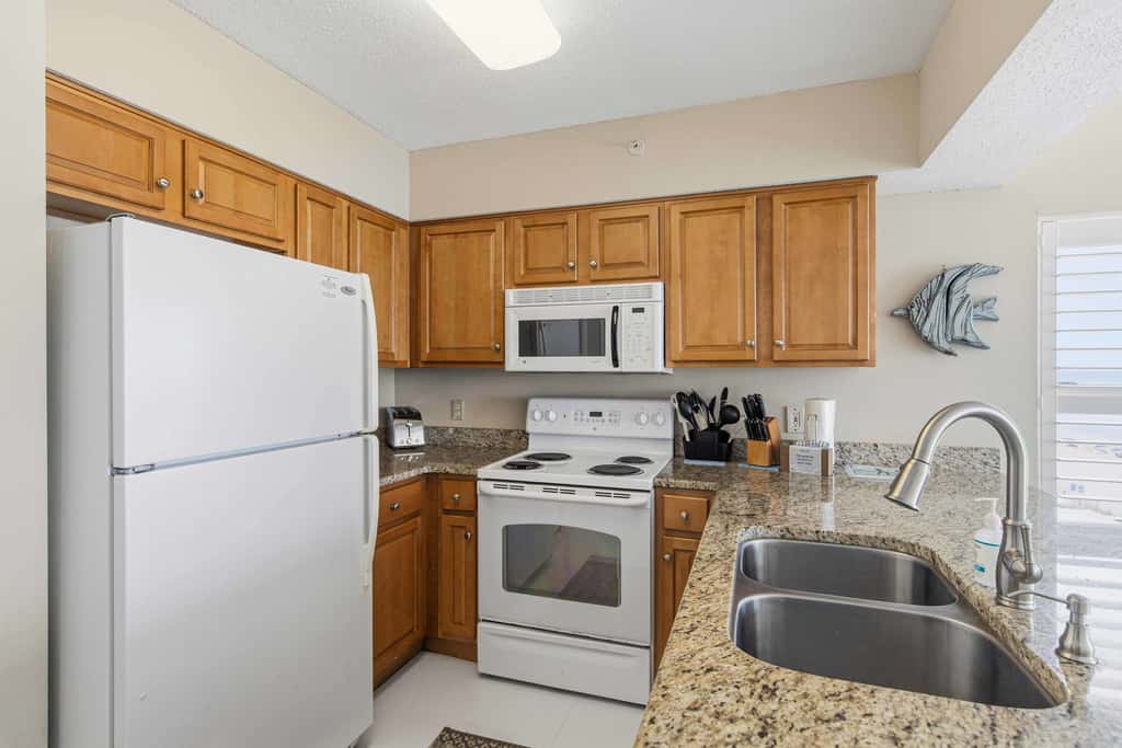 Spacious beachfront condo with full kitchen, shared pool and beach access