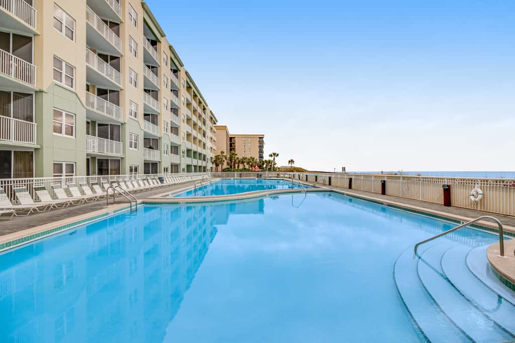 Stunning top-floor condo with balcony, pool, & beach access - great location