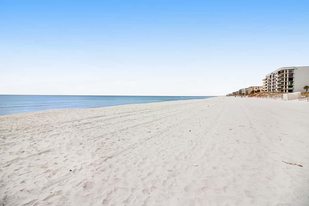 Stunning top-floor condo with balcony, pool, & beach access - great location