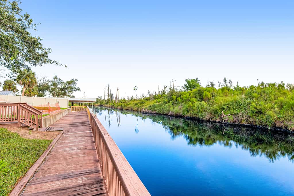 Waterfront Home Close to Beach with Shared Pool, Hot Tub, Free WiFi, & Central AC