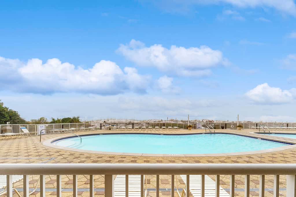 Gulf-front condo with washer/dryer, pools, hot tub, fitness room, & beach access