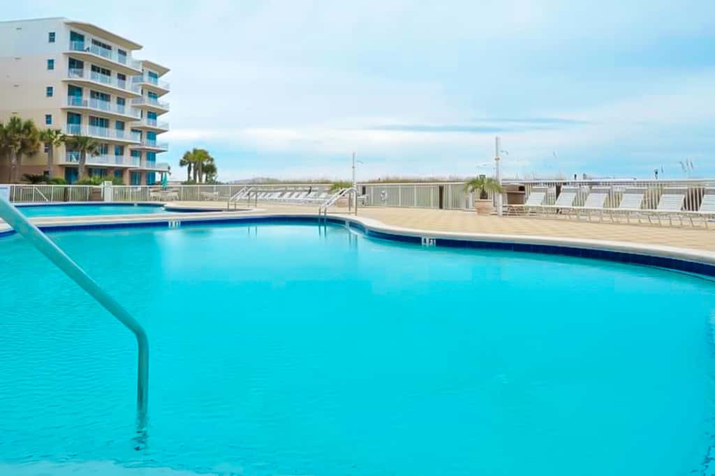 Gulf-front condo with washer/dryer, pools, hot tub, fitness room, & beach access