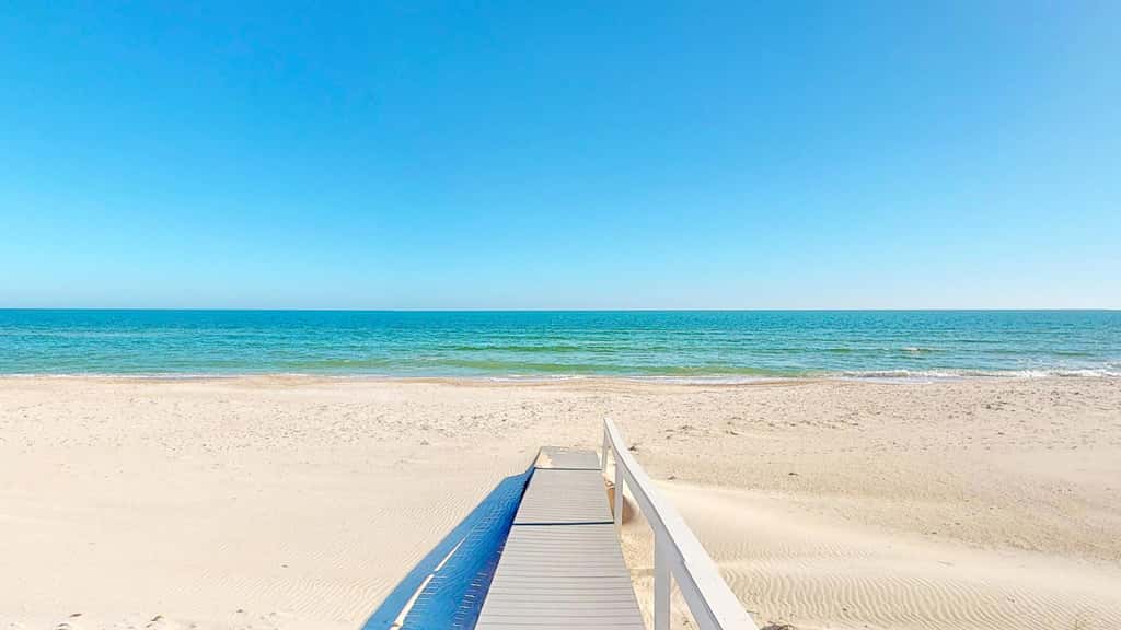 Upscale beachfront home with private hot tub, grill, on-site pools, gym, dogs OK