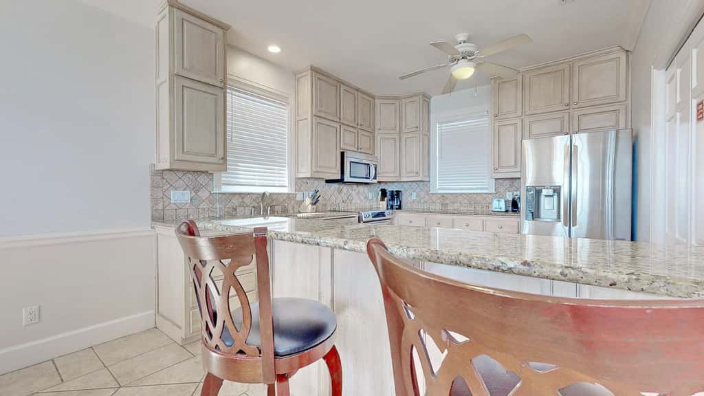 Upscale beachfront home with private hot tub, grill, on-site pools, gym, dogs OK