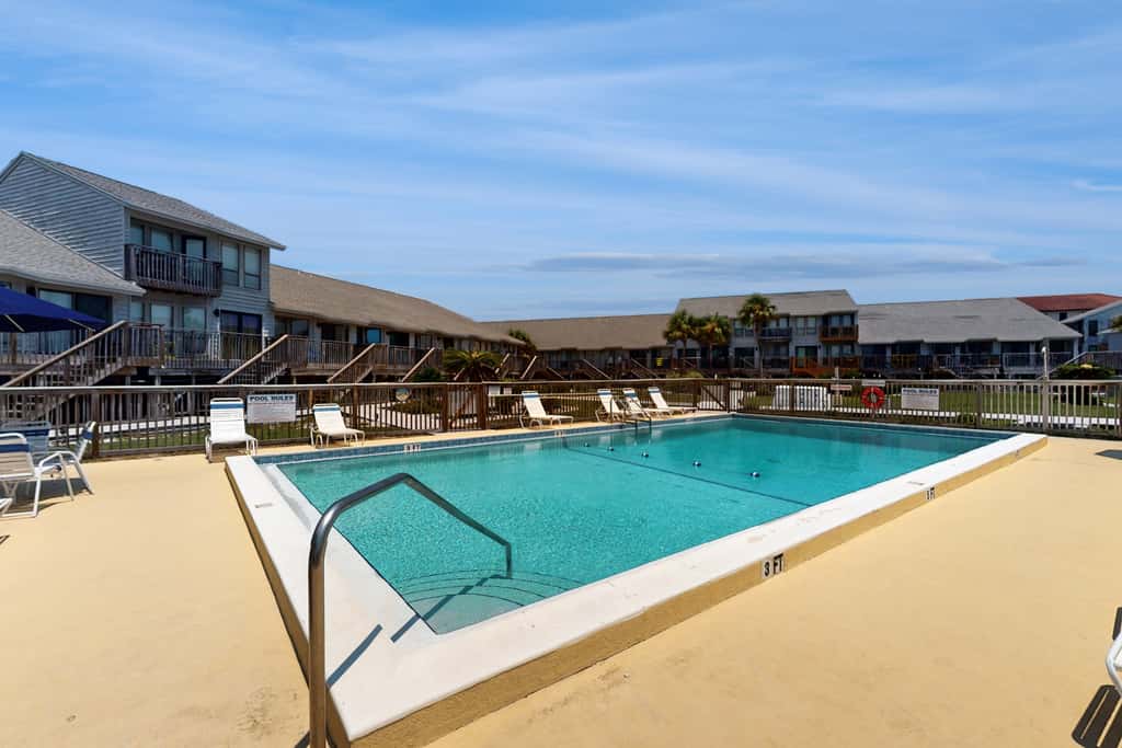 Comfortable townhome steps from beach with pool access, balcony, & WD