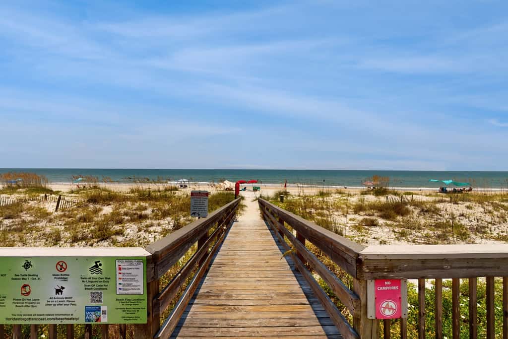 Comfortable townhome steps from beach with pool access, balcony, & WD