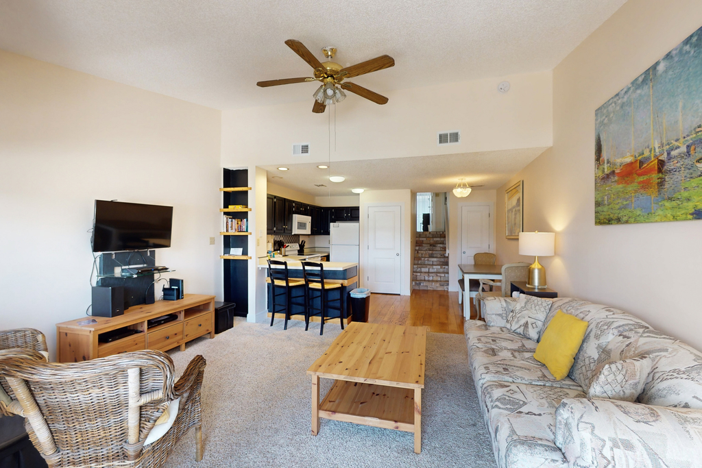 Comfortable townhome steps from beach with pool access, balcony, & WD