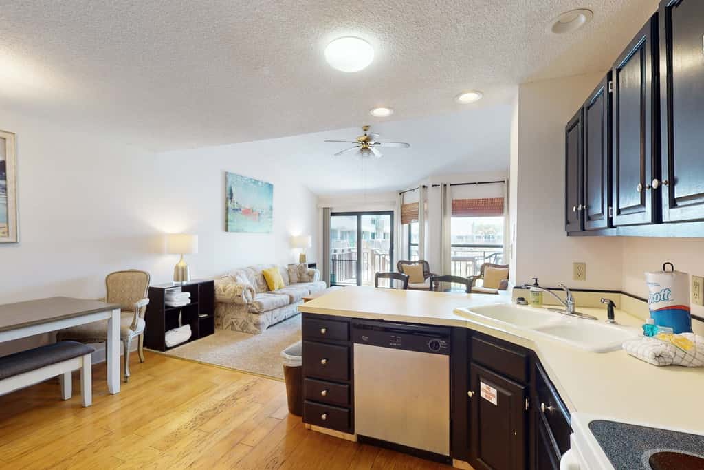 Comfortable townhome steps from beach with pool access, balcony, & WD