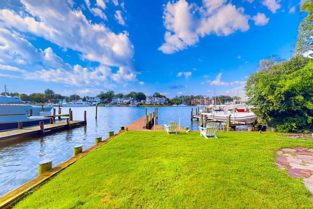 Dog-friendly riverfront home with dock, 2 balconies, waterside patio, & grill