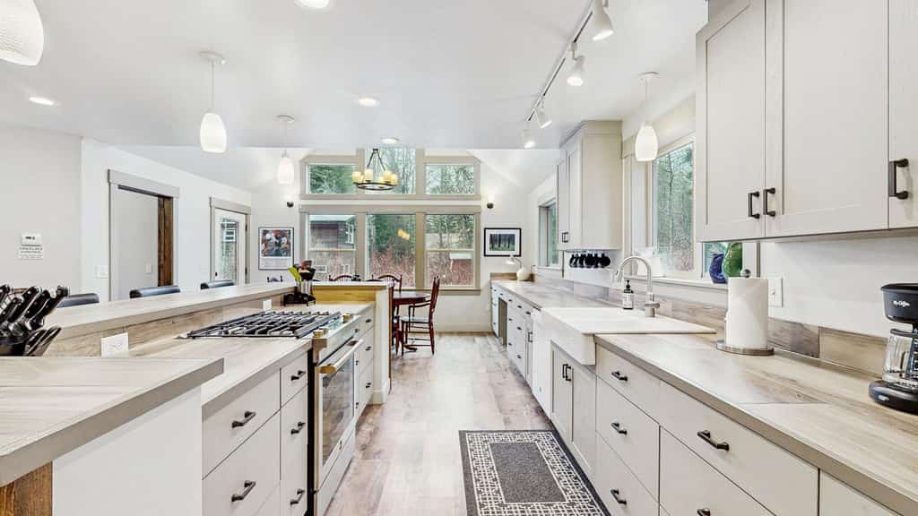 A bright, spacious McCall home designed for groups, featuring a hot tub, dedicated office, and comfortable spaces for gathering. Large windows fill the home with natural light, while the two-level deck with grill and outdoor seating creates an easy indoor-outdoor flow. With two king bedrooms, flexible sleeping options, and room to spread out, it’s ideal for families and groups.
