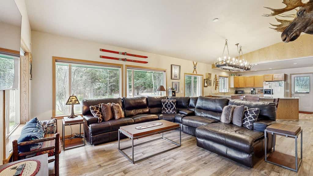 A spacious, dog-friendly McCall retreat with a private hot tub, wraparound deck, and cozy mountain cabin feel. This family-friendly home offers an open layout, updated kitchen countertops, comfortable gathering spaces, and plenty of parking for snowmobile and boat trailers. Conveniently located near Payette Lake, downtown McCall, dining, and year-round outdoor adventure.