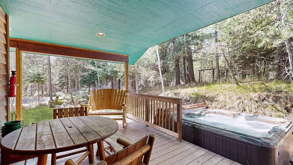 A spacious, dog-friendly McCall retreat with a private hot tub, wraparound deck, and cozy mountain cabin feel. This family-friendly home offers an open layout, updated kitchen countertops, comfortable gathering spaces, and plenty of parking for snowmobile and boat trailers. Conveniently located near Payette Lake, downtown McCall, dining, and year-round outdoor adventure.