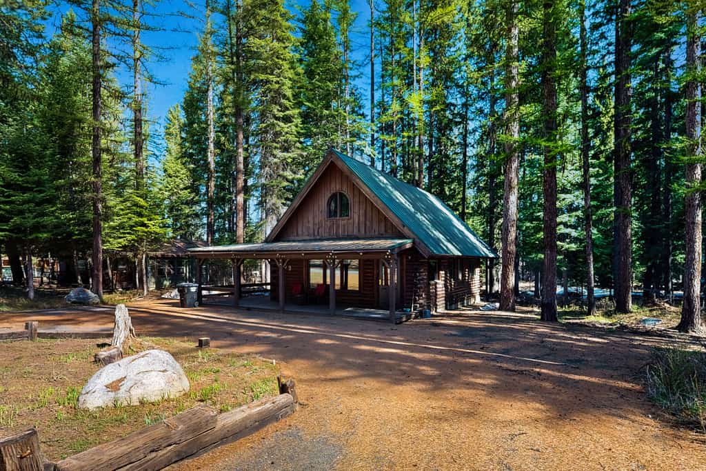 A cozy rustic log cabin less than half a mile from Payette Lake with a covered wraparound deck, vaulted ceilings, and wooded surroundings. Featuring flexible sleeping spaces, two covered outdoor areas, and classic mountain cabin charm, this pet-friendly retreat offers easy access to downtown McCall, lake days, and year-round outdoor adventure.