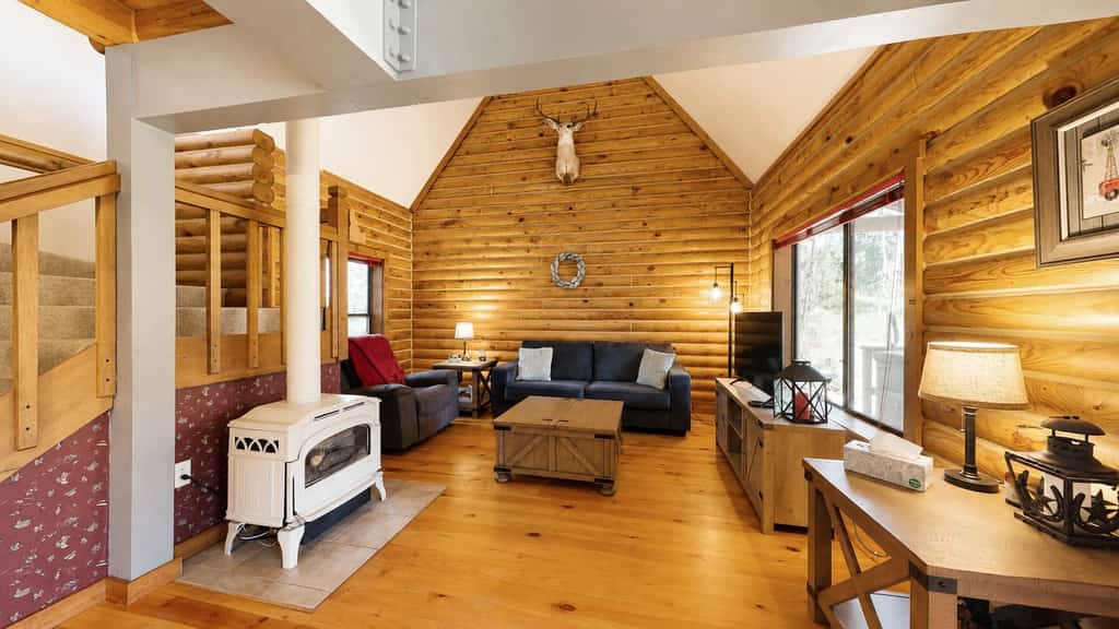 A rustic log cabin tucked into a quiet wooded setting near McCall and Brundage Mountain. Vaulted ceilings, a spacious loft living area, and a large deck with outdoor seating create an easy place to relax after a day exploring the mountains. Features include a fireplace (propane), flatscreen TVs, forest views, and flexible sleeping space for families and groups.