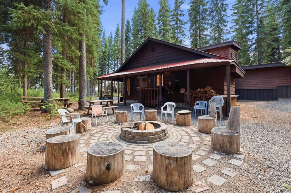 A short walk from Payette Lake, this charming, newly updated, single-level McCall cabin offers lake views through the trees and access to three private sandy beaches within a short walk. Inside, enjoy three bedrooms, a bunk alcove, two bathrooms, an updated kitchen with a wood-burning stove, and multiple living spaces. Outdoor areas provide room to relax and play, while flexible parking accommodates vehicles, boats, trailers, RVs, and snowmobiles.