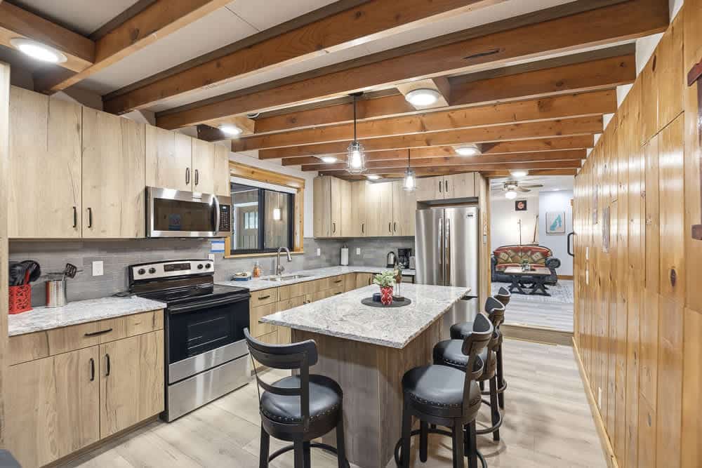 A short walk from Payette Lake, this charming, newly updated, single-level McCall cabin offers lake views through the trees and access to three private sandy beaches within a short walk. Inside, enjoy three bedrooms, a bunk alcove, two bathrooms, an updated kitchen with a wood-burning stove, and multiple living spaces. Outdoor areas provide room to relax and play, while flexible parking accommodates vehicles, boats, trailers, RVs, and snowmobiles.