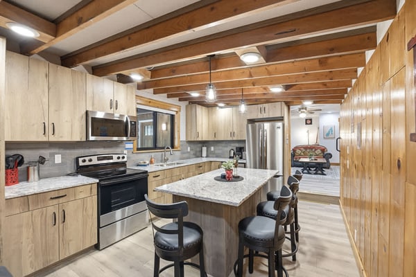 A short walk from Payette Lake, this charming, newly updated, single-level McCall cabin offers lake views through the trees and access to three private sandy beaches within a short walk. Inside, enjoy three bedrooms, a bunk alcove, two bathrooms, an updated kitchen with a wood-burning stove, and multiple living spaces. Outdoor areas provide room to relax and play, while flexible parking accommodates vehicles, boats, trailers, RVs, and snowmobiles.