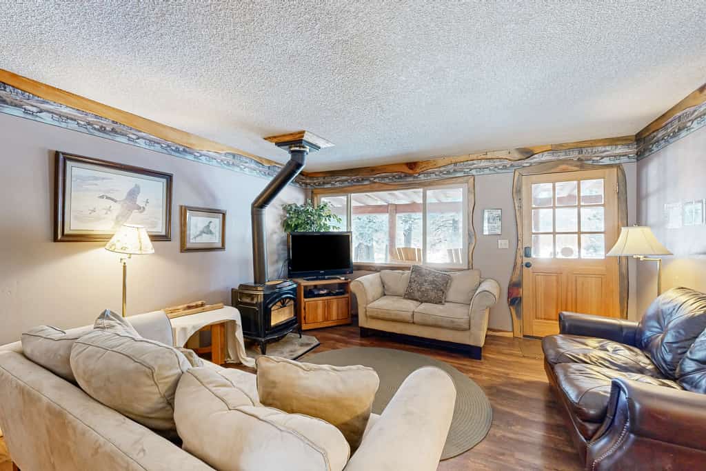 A secluded ranch cabin near Lake Cascade with views of the Payette River and hundreds of acres to explore. Designed for families, the home features two living rooms, separated bedroom wings, and two decks for outdoor dining and relaxing. Located 7 miles from Donnelly and 18 miles from McCall.