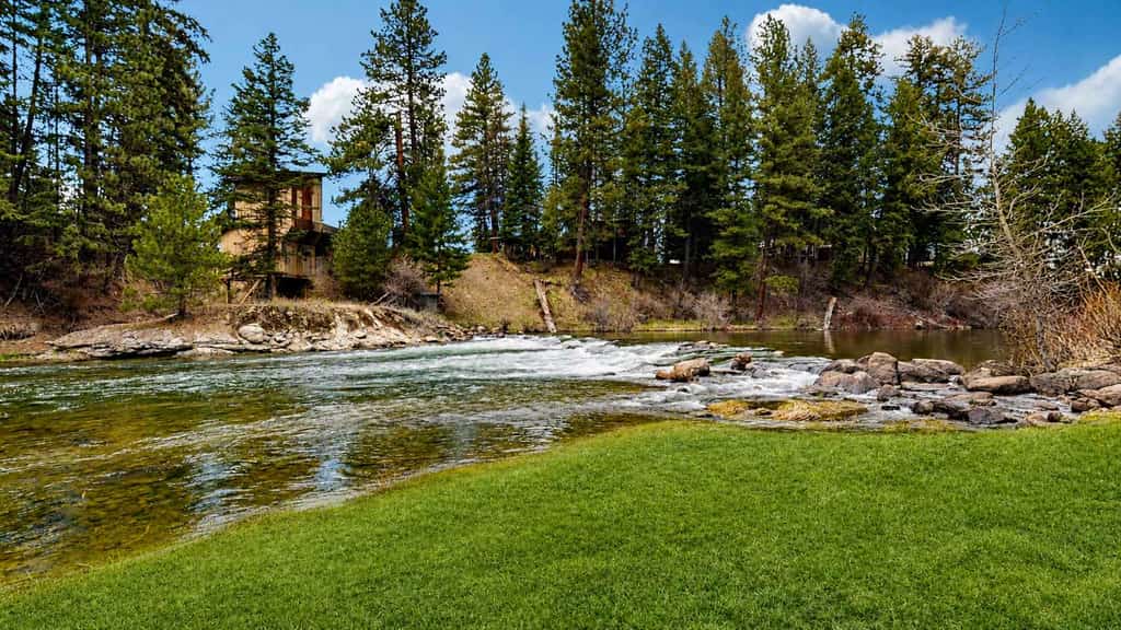 Set along the river in McCall, this home offers a peaceful setting with water views, easy access to town, and .3  miles (6 min walk) to Rotary Park beach and playground on Payette Lake. The main living spaces are all positioned to take in the river, with a patio just outside that’s perfect for morning coffee or slow evenings. With a mix of private bedrooms and shared spaces, it’s a comfortable option for families or small groups, with access to pool (summer only) and tennis amenities.