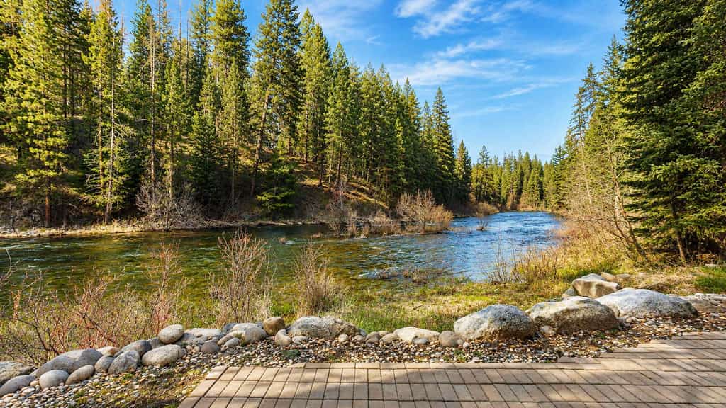 A private riverfront McCall retreat with multiple living spaces, stunning Payette River views, and resort-style amenities at home. Four bedrooms, a loft overlooking the river, a hot tub, sauna, air conditioning, and riverside fire pit create an unforgettable setting for families and groups looking to relax and reconnect.