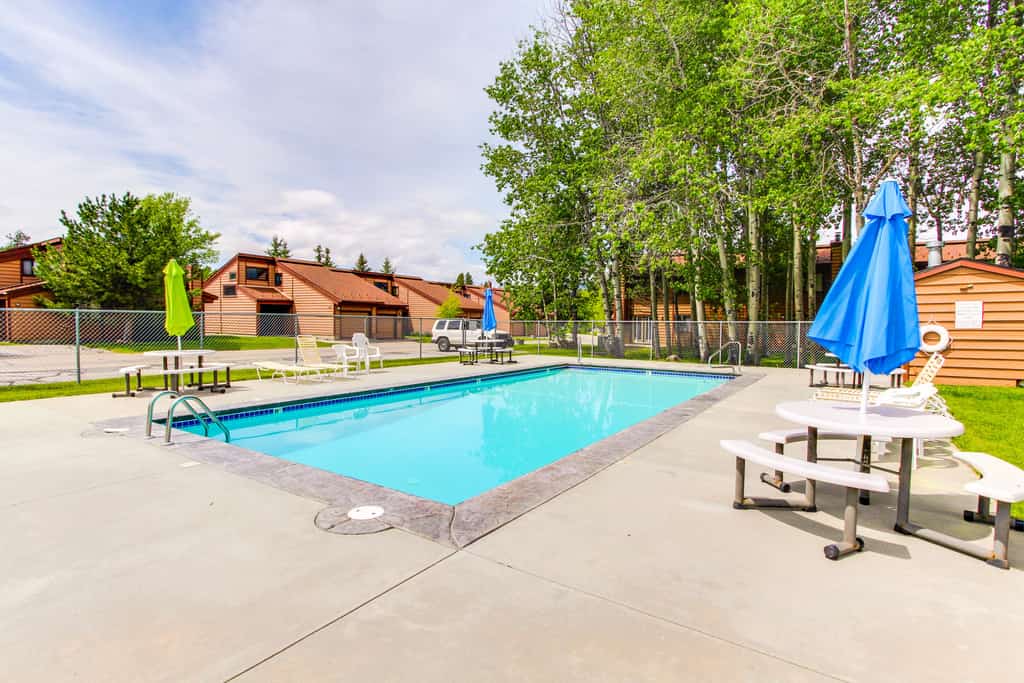 A bright end-unit condo in Aspen Village with wooded views, thoughtful mountain decor, and access to resort-style community amenities including pools, hot tub, sauna, fitness center, and sports courts. Featuring two king suites, oversized living room seating, a wood-burning fireplace, and easy access to downtown McCall and Payette Lake, this comfortable retreat is ideal for relaxing mountain getaways year-round.