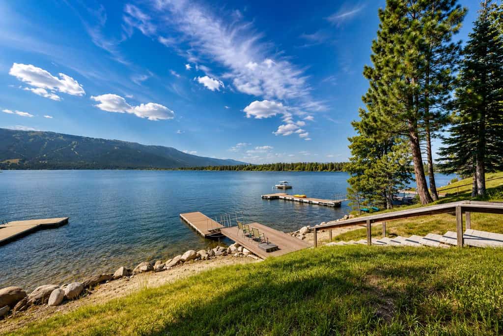 A stunning waterfront log cabin on Lake Cascade with a private dock, expansive deck, and incredible views across the lake to Tamarack Resort. Designed for memorable group getaways, this three-level retreat features a grand stone fireplace, multiple game areas, lakefront outdoor living, and flexible sleeping spaces for families and friends to gather year-round.
