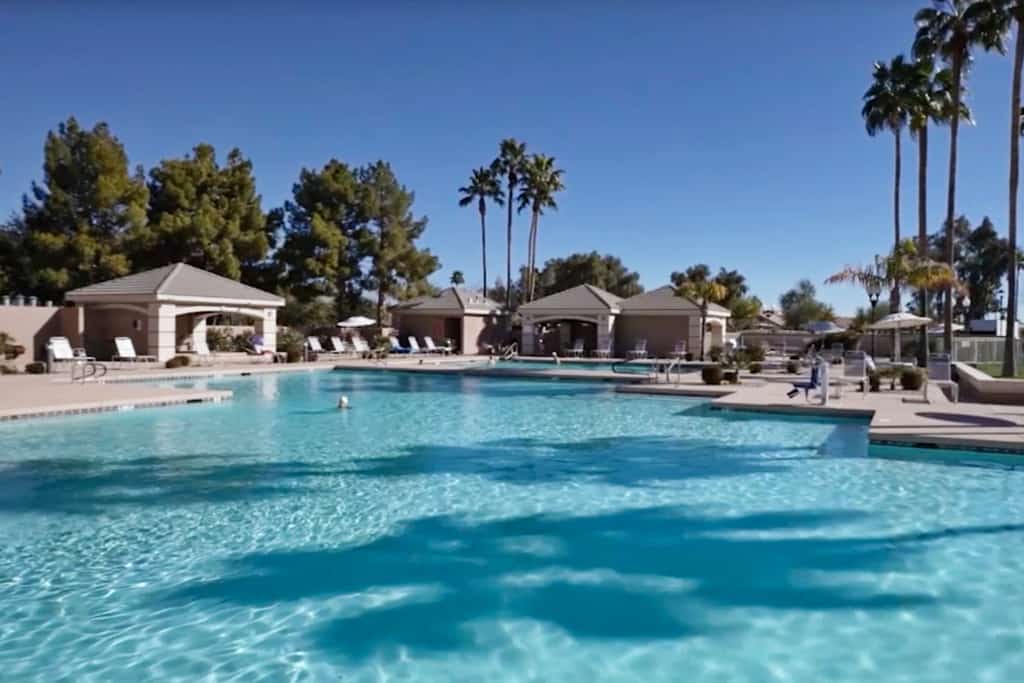 Palm-lined home with pool access, grill, office & golf course views