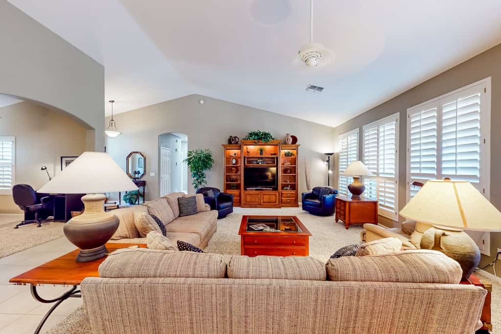 Palm-lined home with pool access, grill, office & golf course views