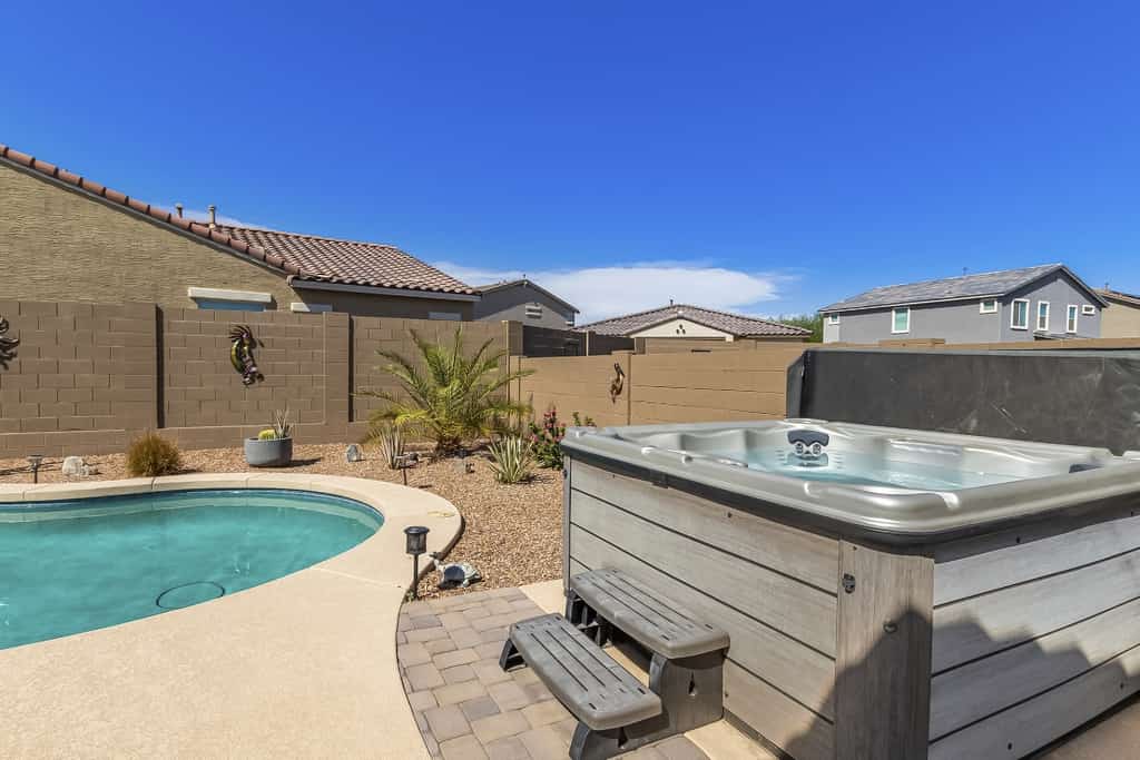 Airy desert home with an enclosed yard, private pool, hot tub, firepit, & W/D