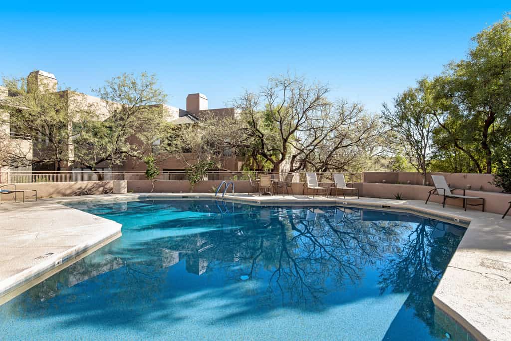 Radiant retreat with pool and hot tub access, sunroom, washer/dryer, gym, & AC