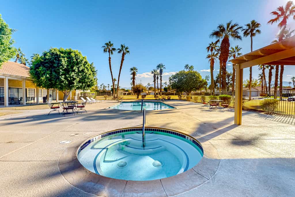 Gated community home with 2 pools, hot tubs, private patio, AC, & W/D